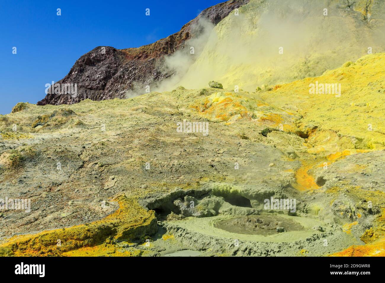 Landscape on White Island, an active volcano in the Bay of Plenty, New Zealand. A bubbling mudpot on a sulfur-stained hillside Stock Photo