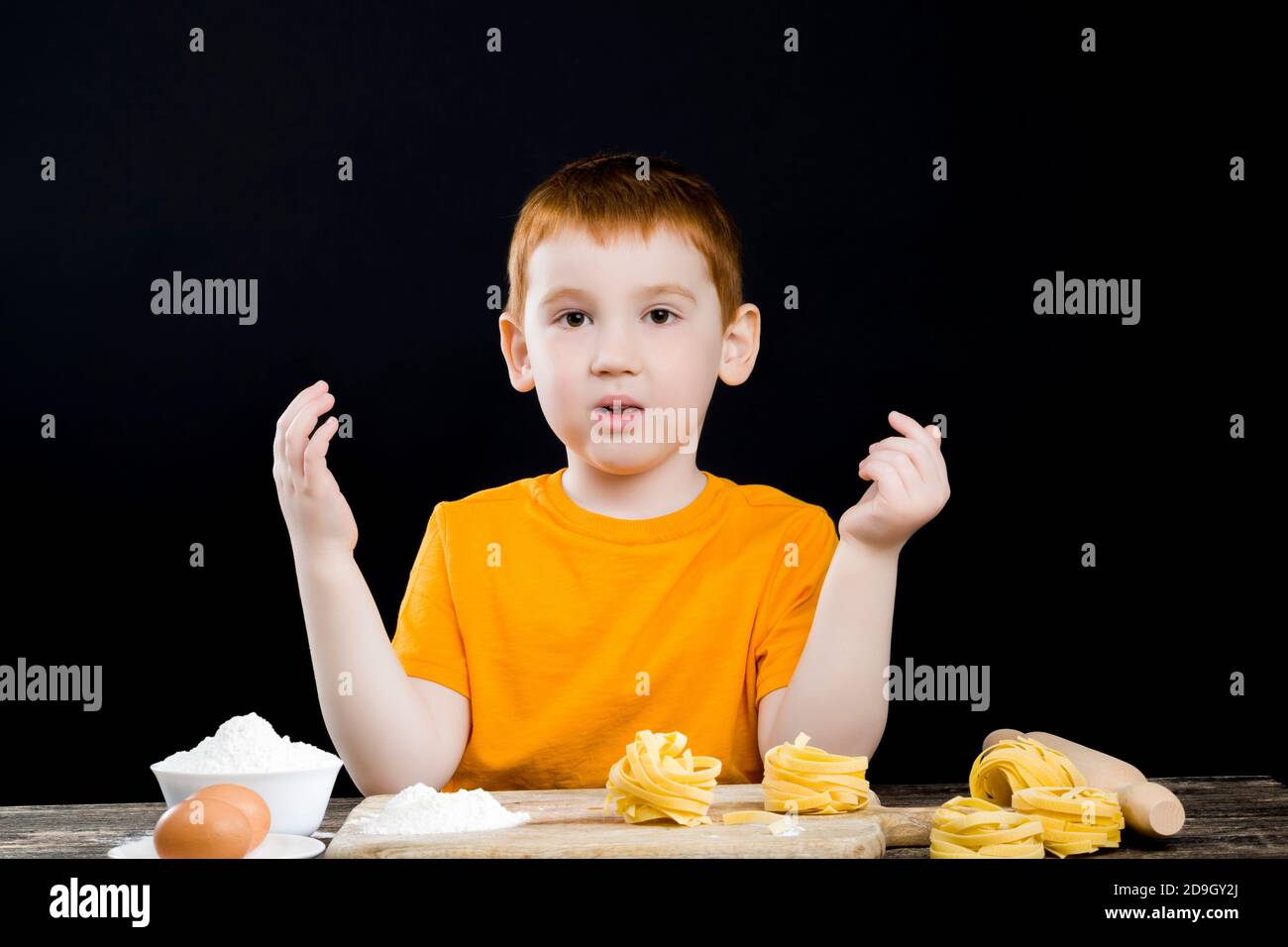 child in the kitchen to cook pasta Stock Photo