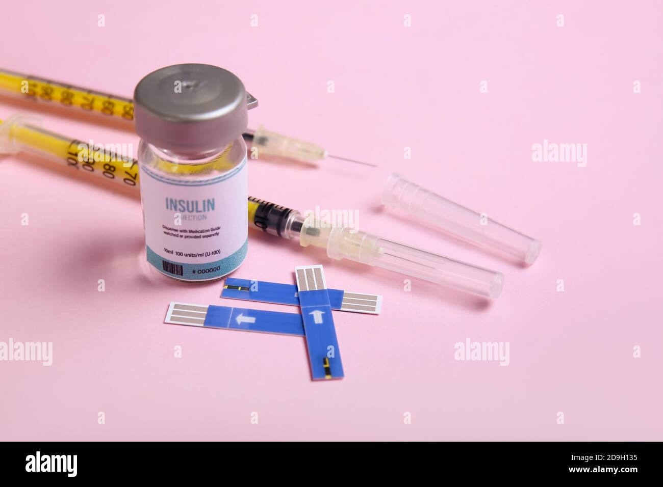 Bottle of insulin with syringes and test strips of glucometer on color background. Diabetes concept Stock Photo