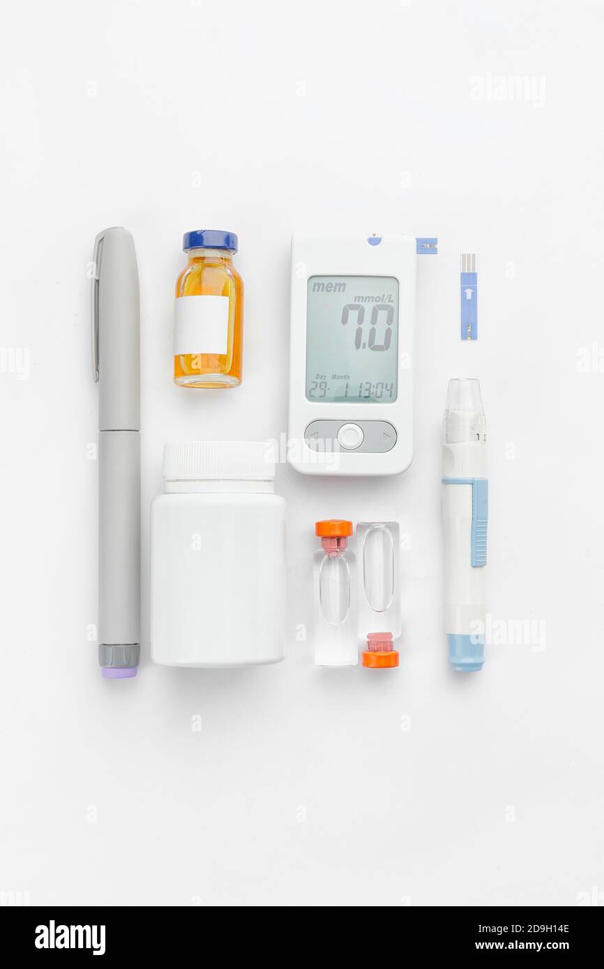 lancet pens, pills and bottles of insulin on white