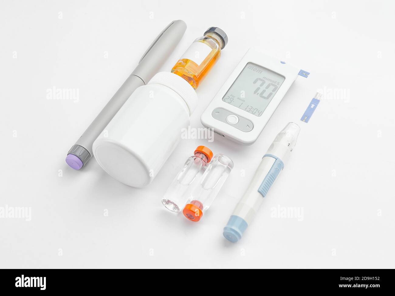 lancet pens, pills and bottles of insulin on white