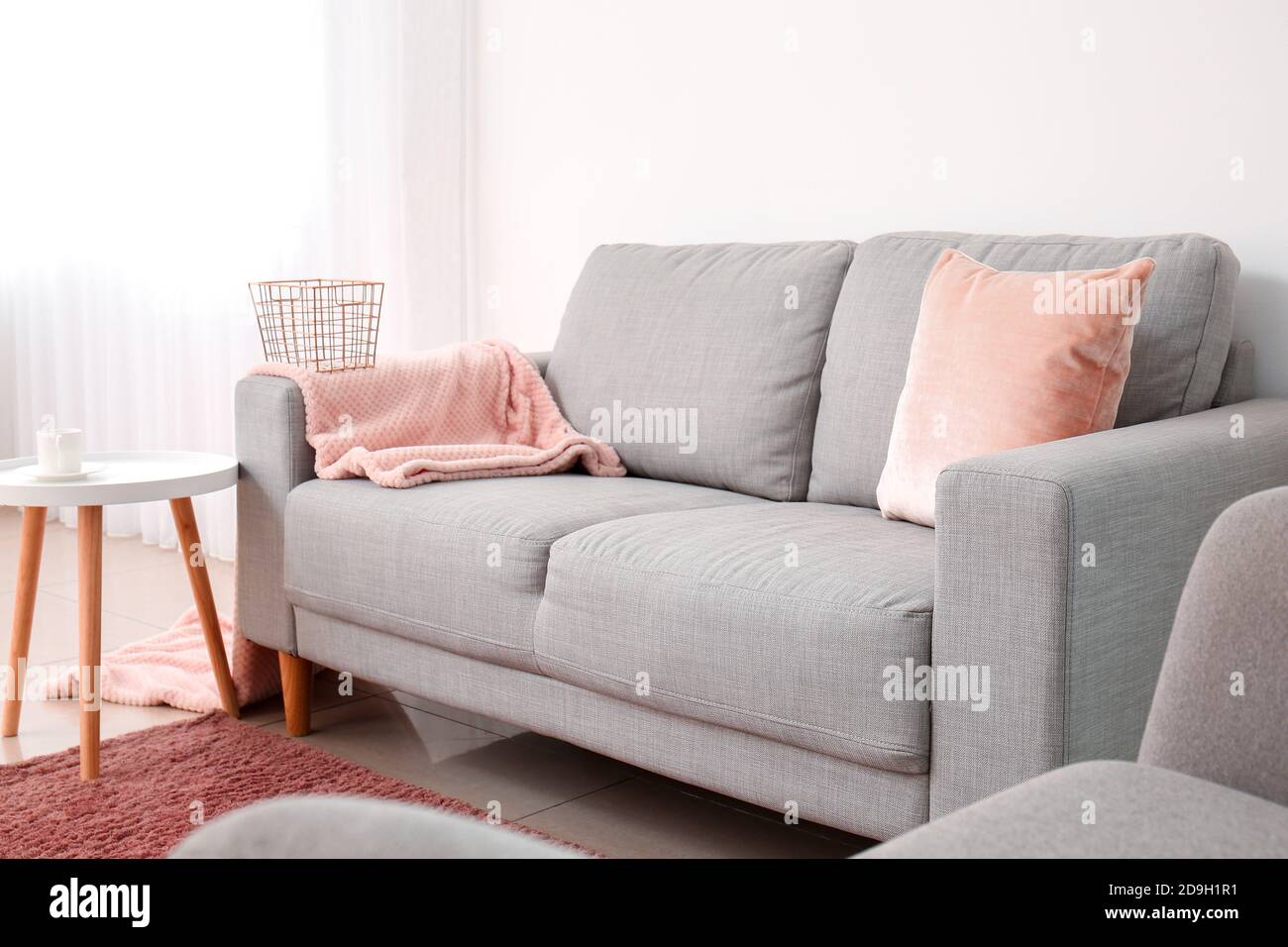 Interior of modern living room with grey sofa Stock Photo - Alamy