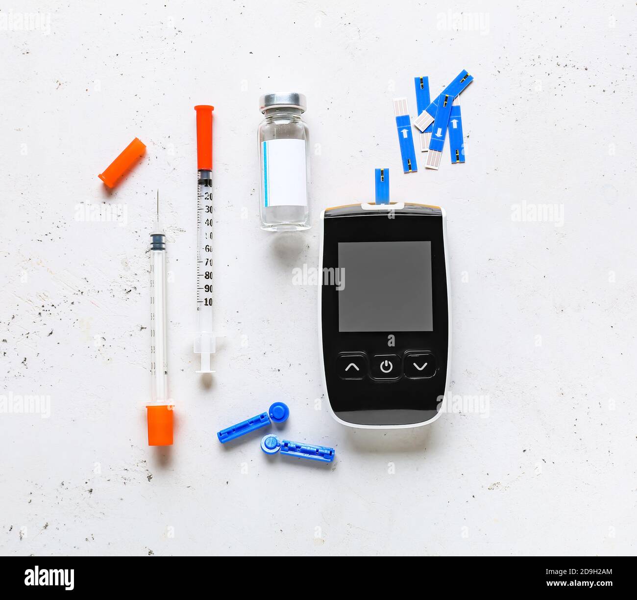Glucometer, test strips, insulin and syringes on white background. Diabetes concept Stock Photo