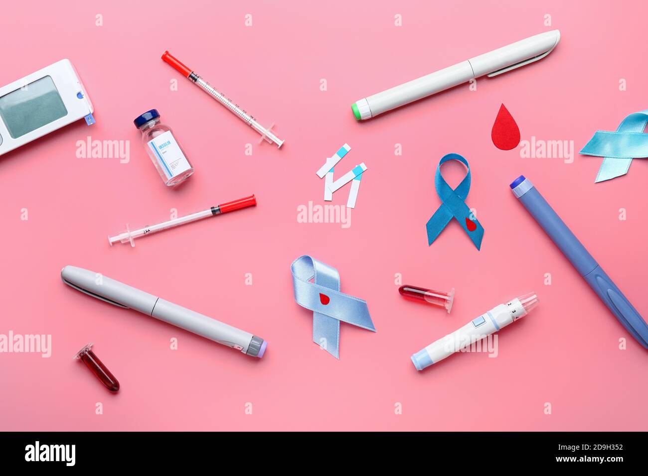 Awareness ribbons with glucometer, blood samples, syringes and lancet ...