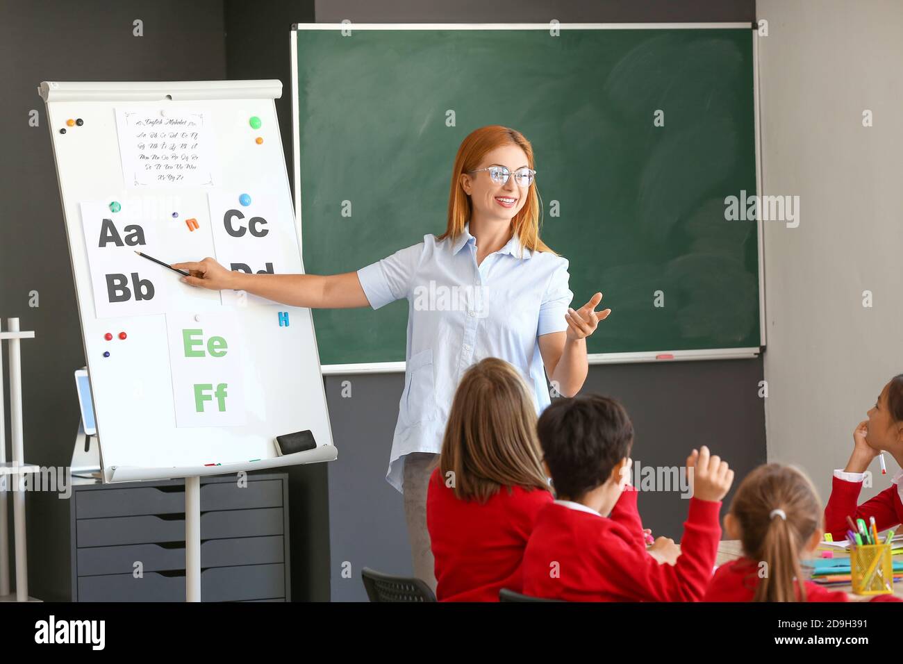 Teacher conducting lesson in classroom Stock Photo - Alamy