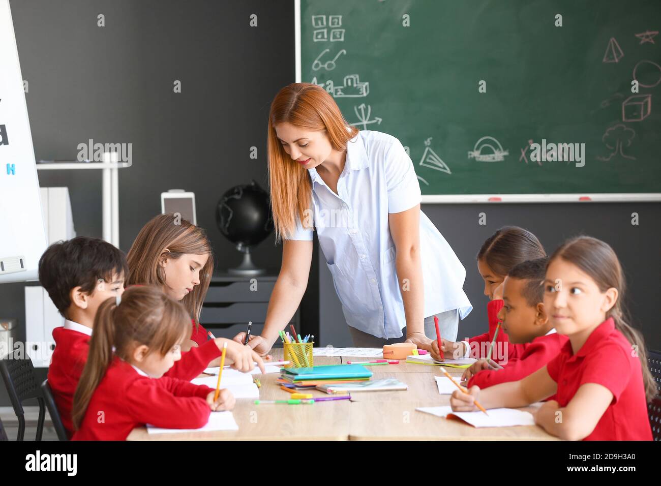 Teacher conducting lesson in classroom Stock Photo - Alamy