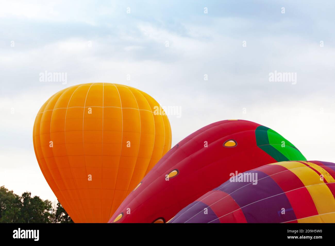 three balloons against cloudy skies Stock Photo