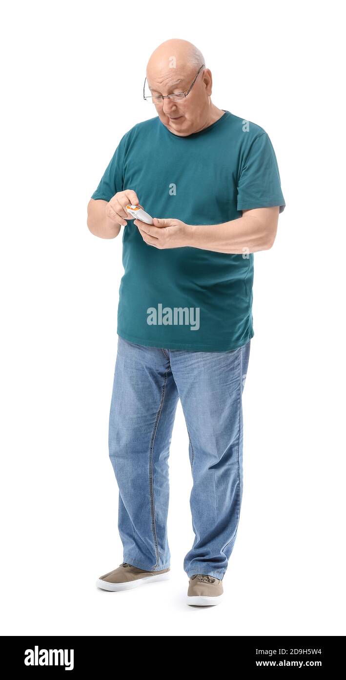 Senior diabetic man checking blood sugar level on white background Stock Photo