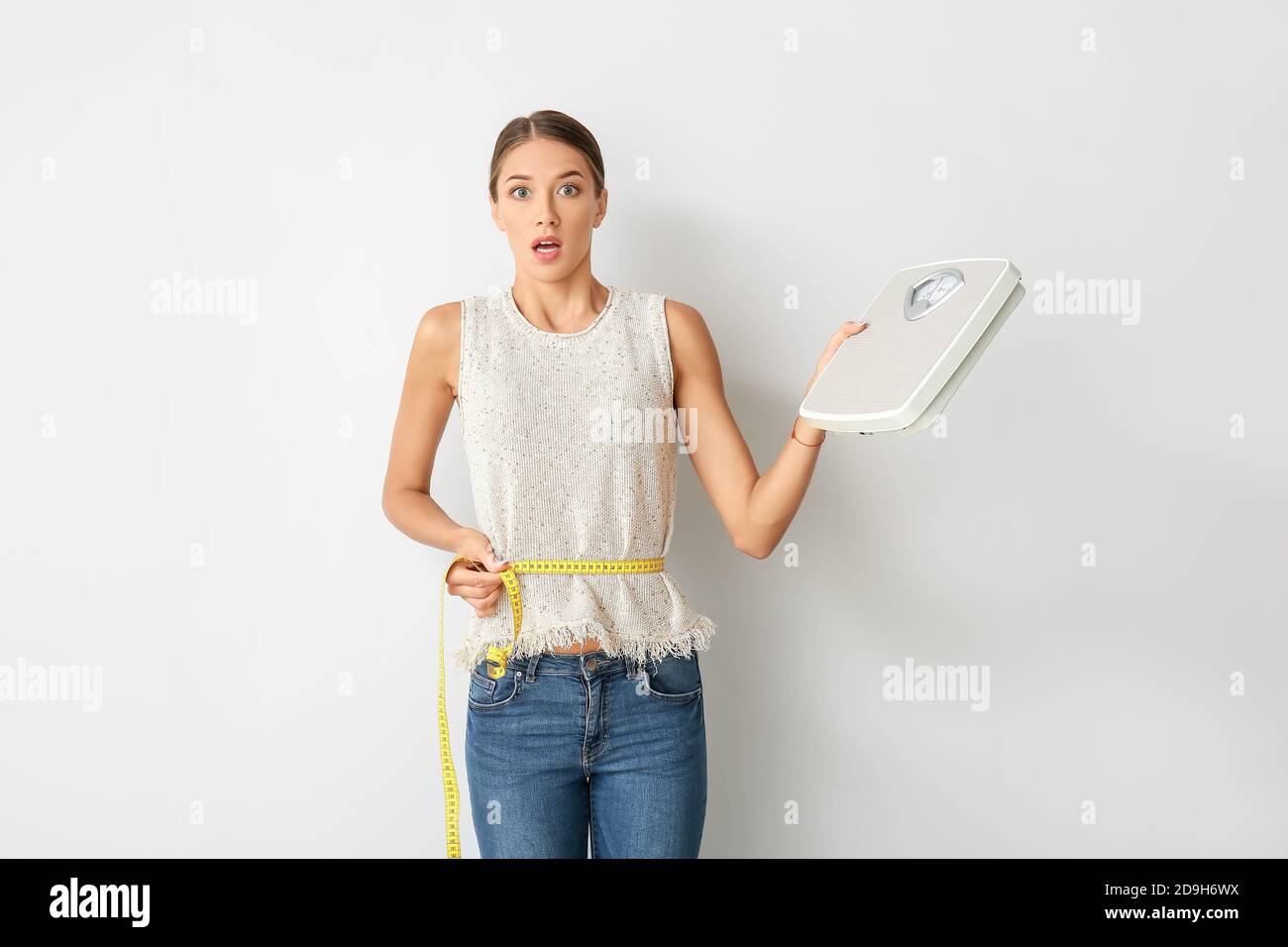 Woman with sudden weight loss problem on light background. Diabetes