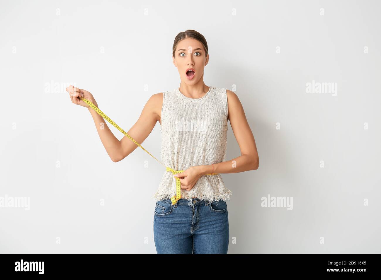 Woman with sudden weight loss problem on light background. Diabetes