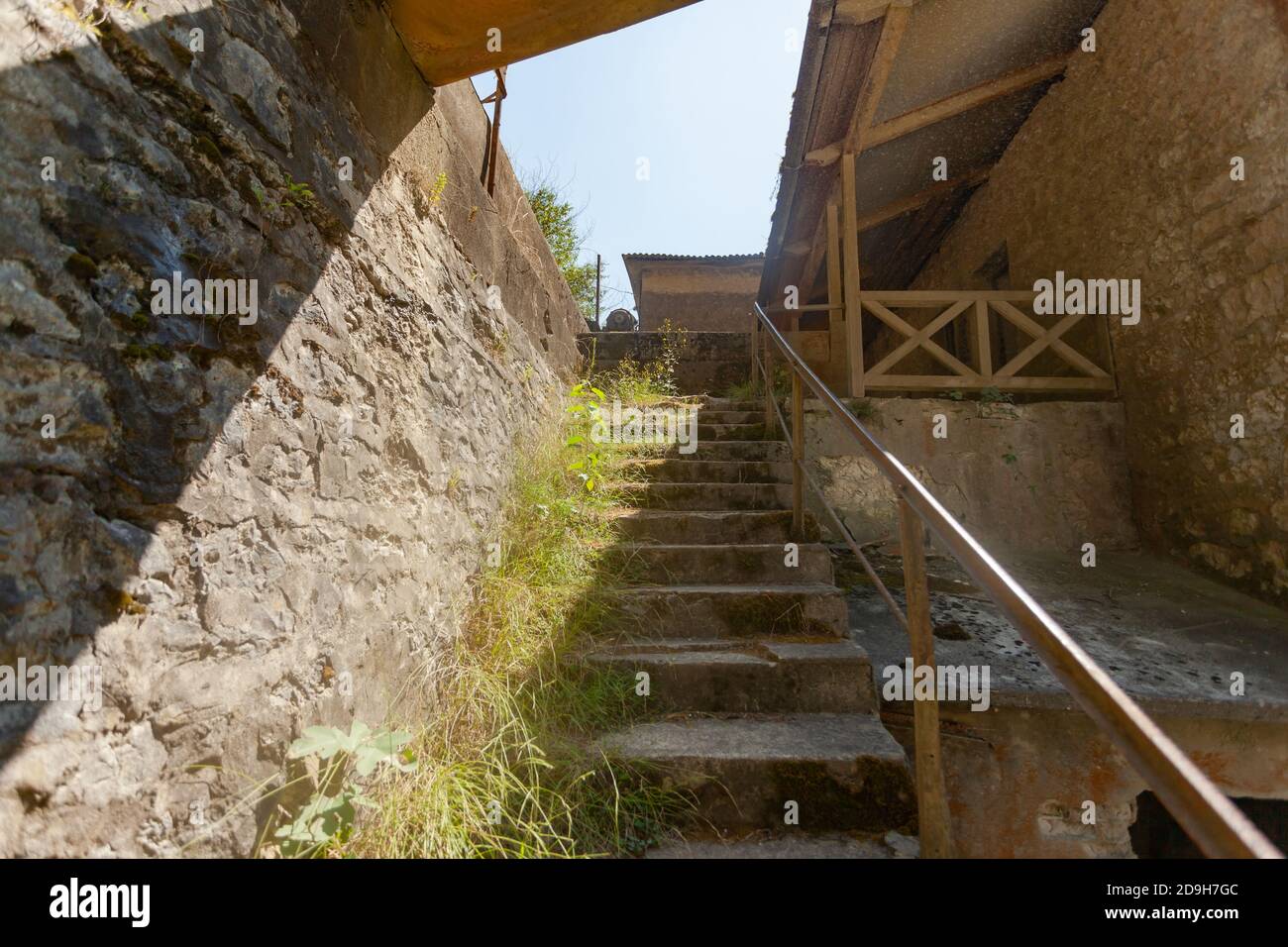 An old stone staircase along the steep wall Stock Photo