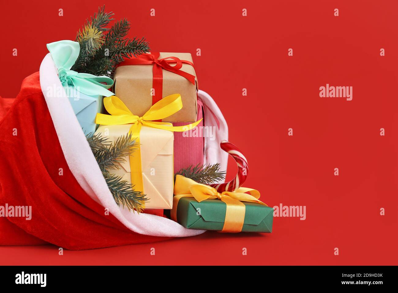 Santa Claus bag full of gifts on color background Stock Photo - Alamy