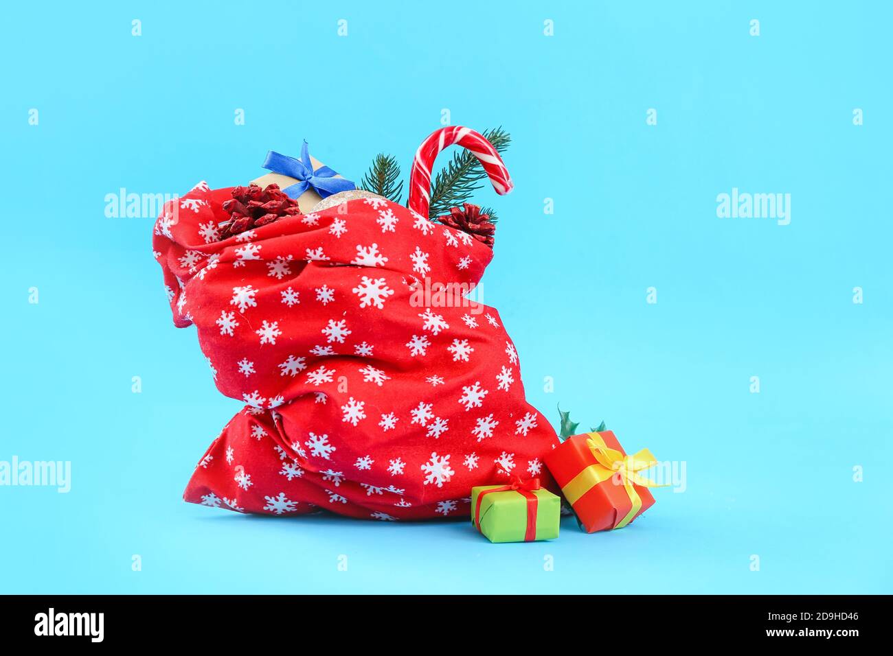 Santa Claus bag full of gifts on color background Stock Photo - Alamy