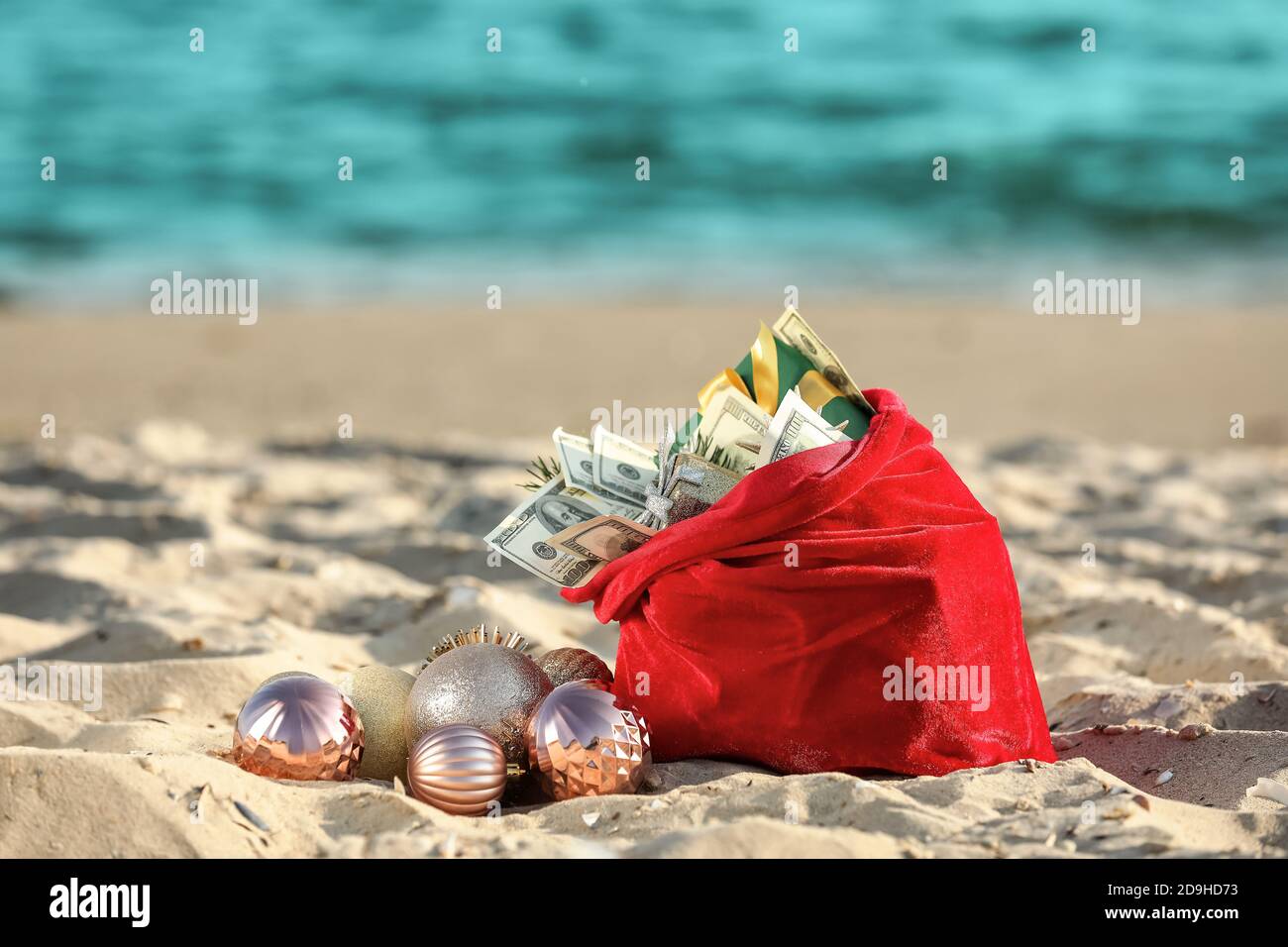 Santa Claus bag with gifts on beach Stock Photo - Alamy