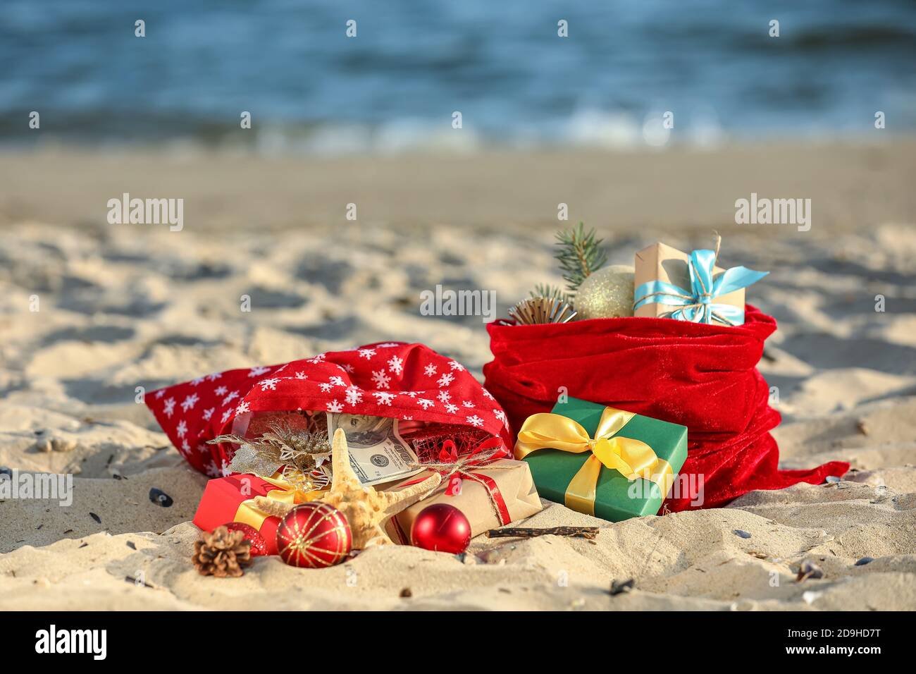 Santa Claus bags with gifts on beach Stock Photo - Alamy