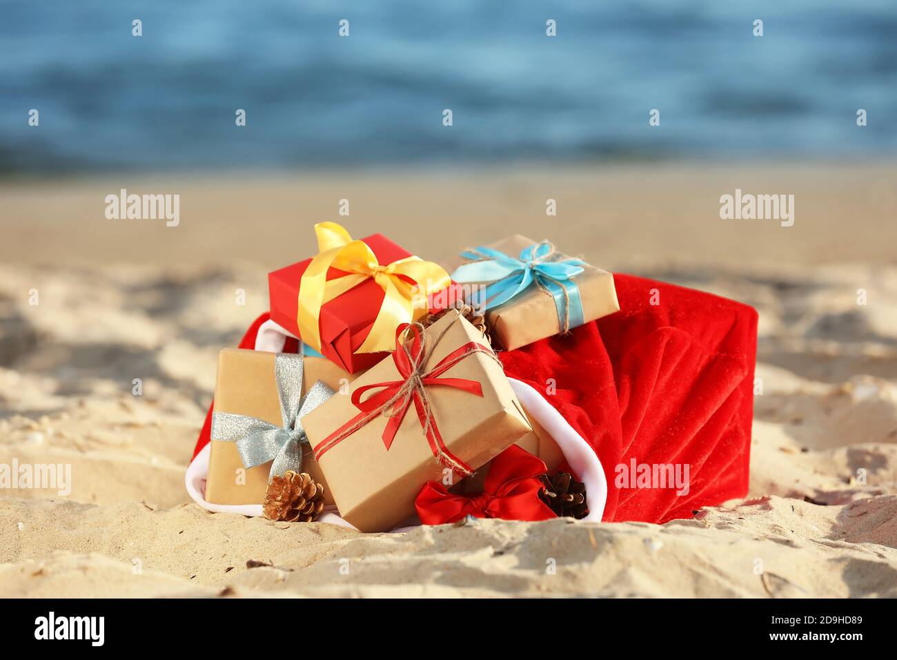 Santa Claus bag with gifts on beach Stock Photo - Alamy