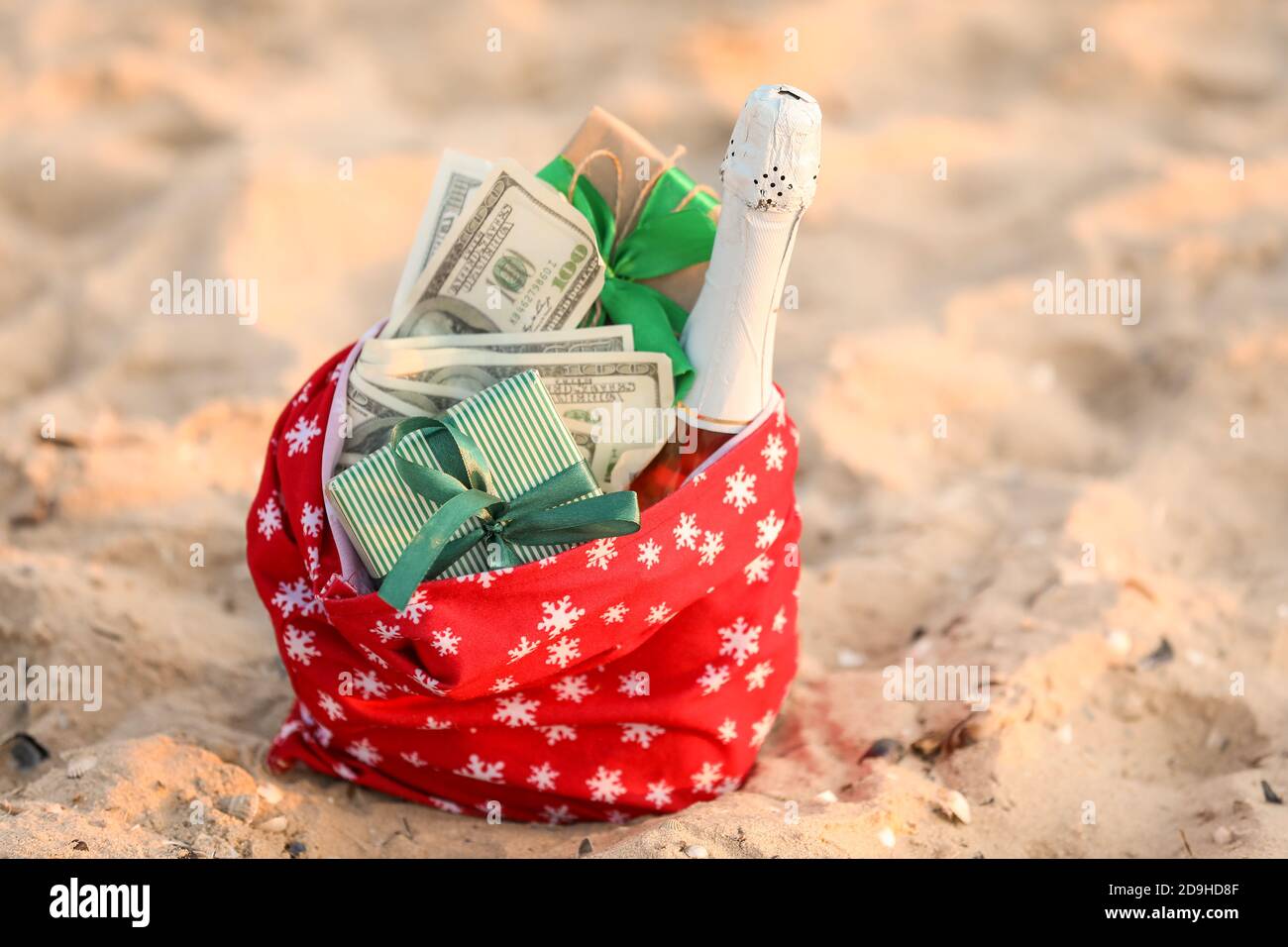 Santa Claus bag with gifts on beach Stock Photo - Alamy