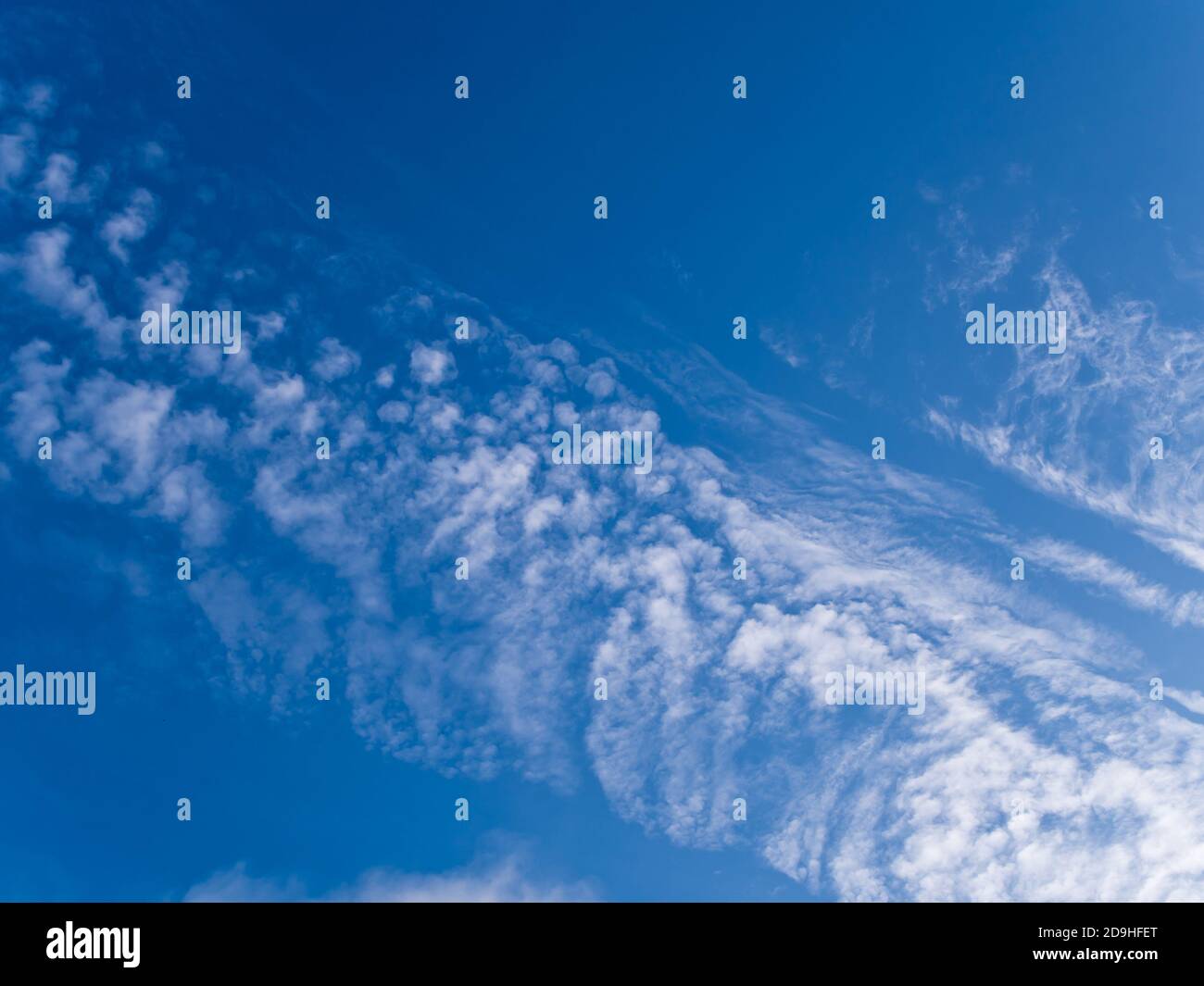 Fluffy clouds in the bright blue sky Stock Photo - Alamy