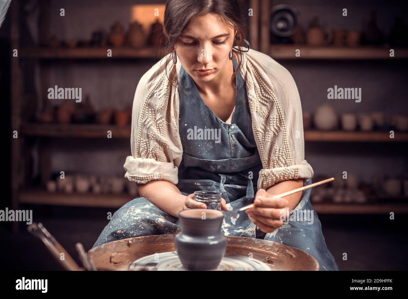 Beautiful ceramist master demonstrates the process of making ceramic