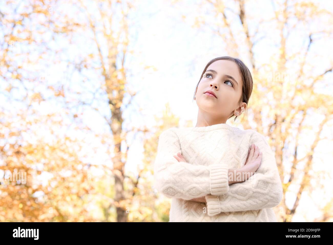 Cute little girl in autumn park Stock Photo - Alamy