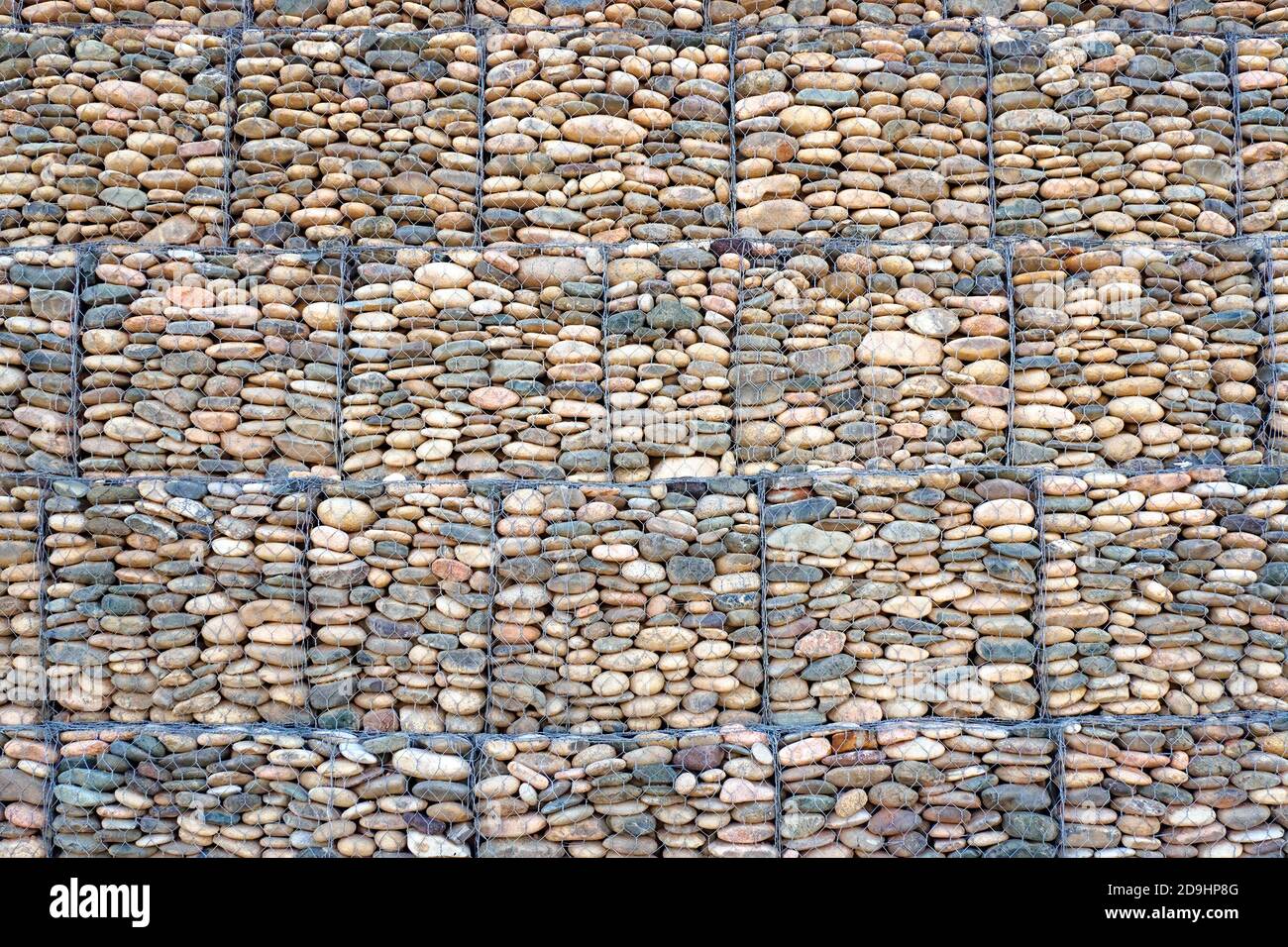 Stone gabion wall texture background. Fence from mesh and stone for erosion control. Stock Photo