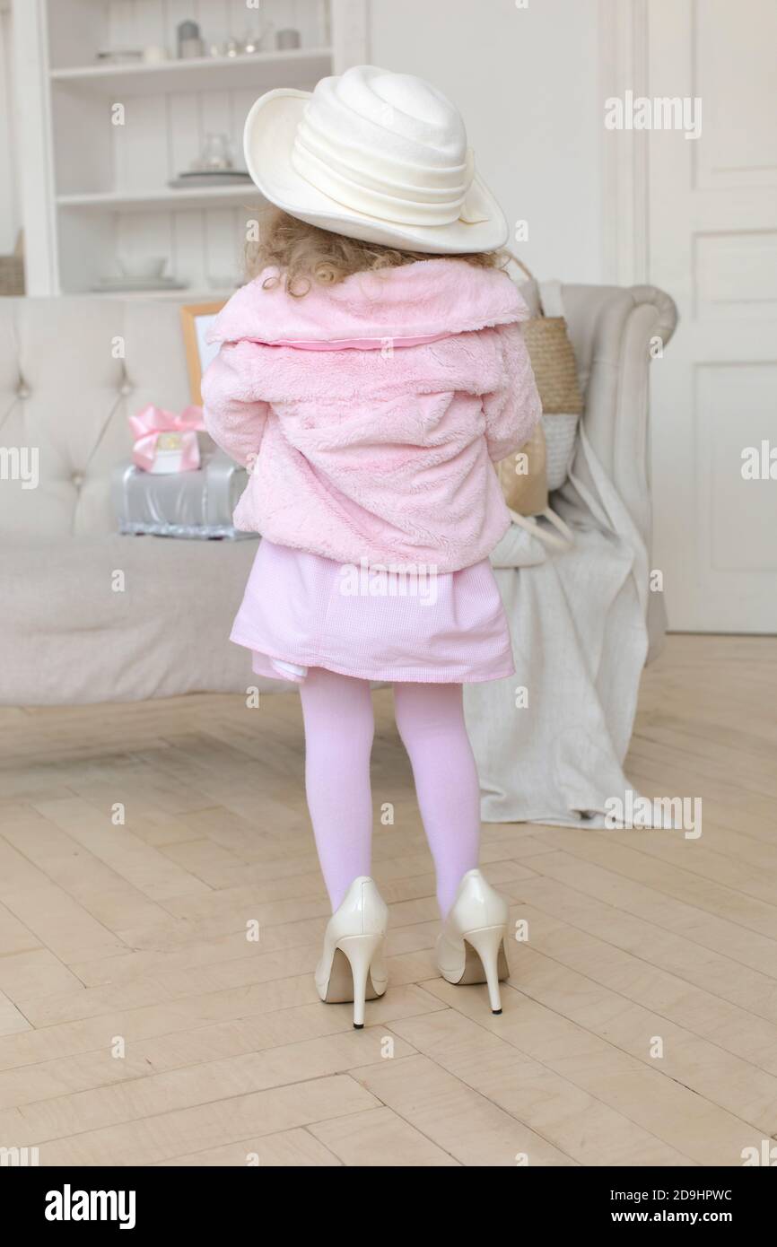 Cute girl in high heels in room Stock Photo