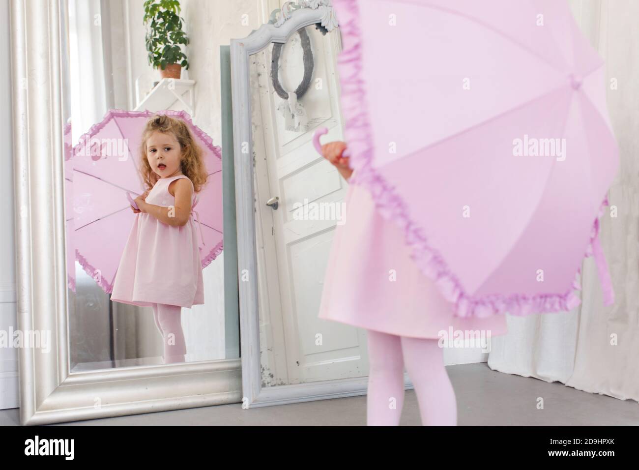 Cute girl in front of mirror at home Stock Photo