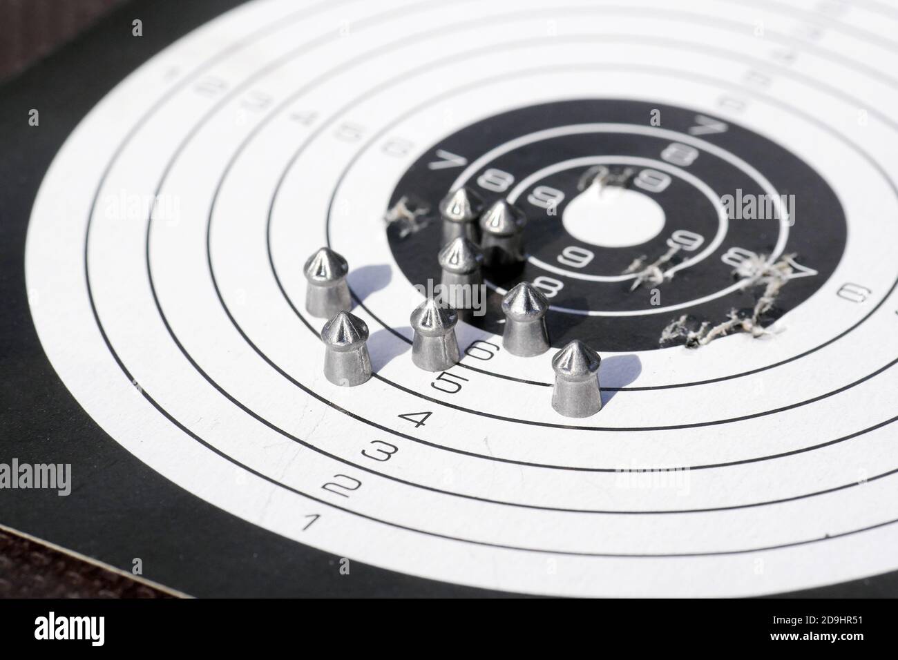 closeup of paper shooting target with bullet holes and airgun pellets Stock Photo