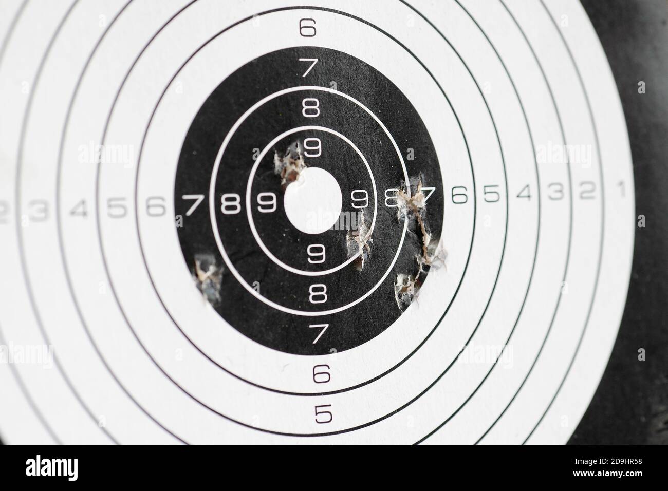 closeup of papaer shooting target with bullet holes Stock Photo