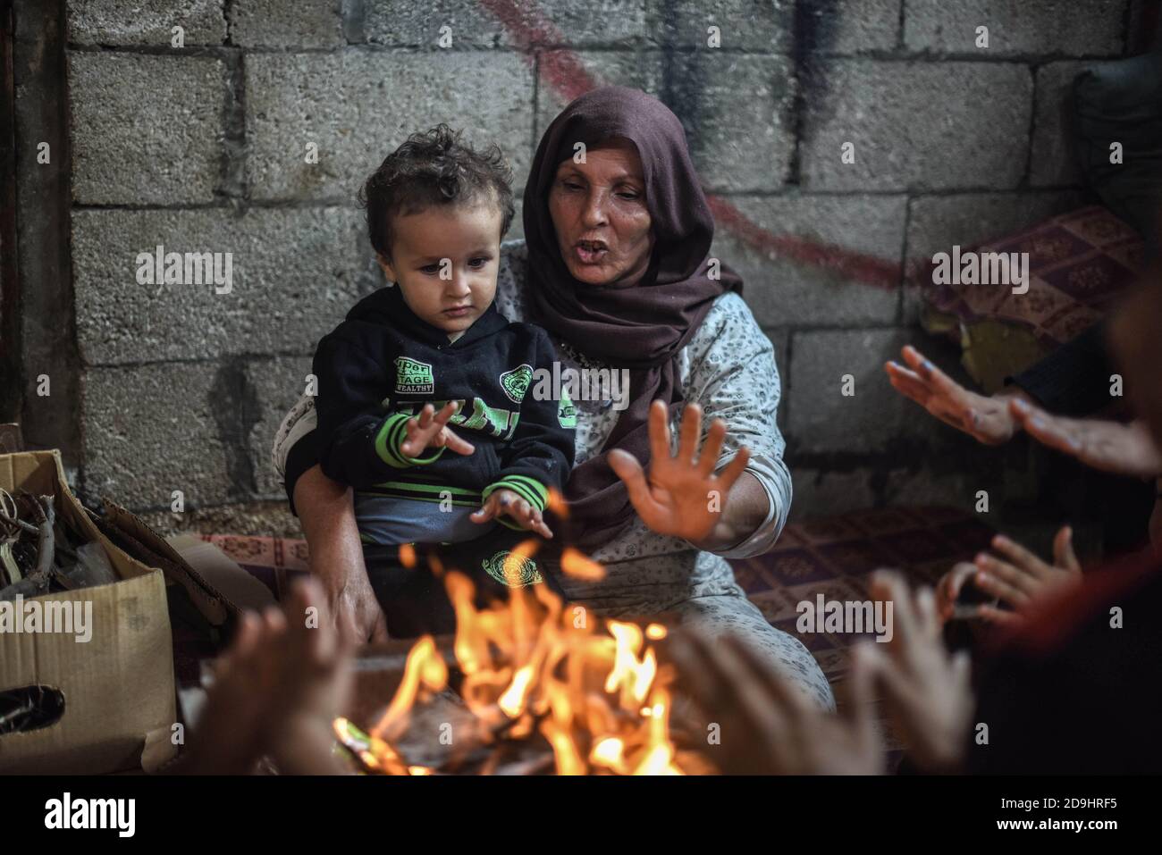Gaza, Palestine. 05th Nov, 2020. A family keeping warm around a house ...