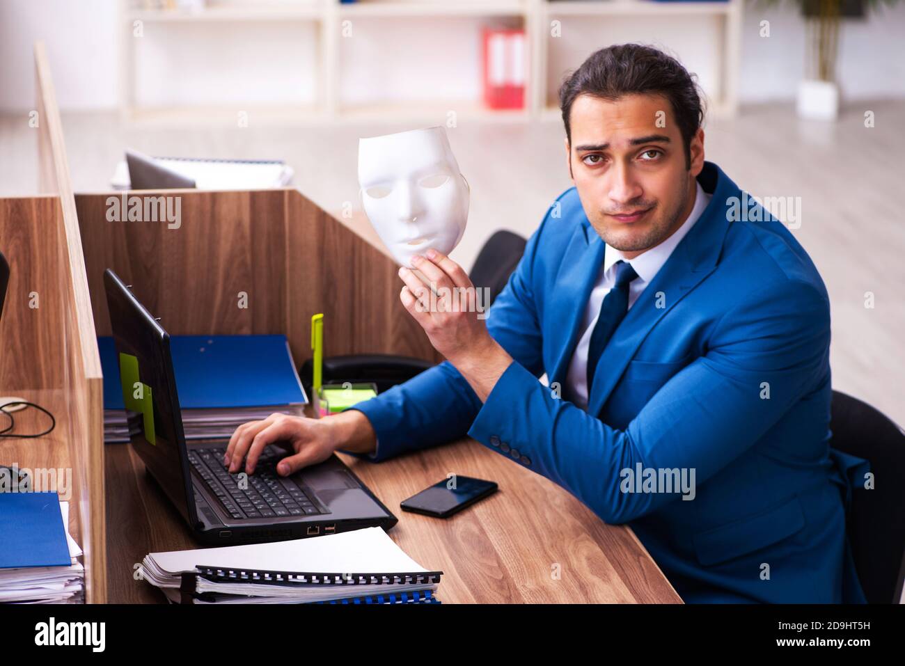 Young employee wearing mask in the office Stock Photo - Alamy