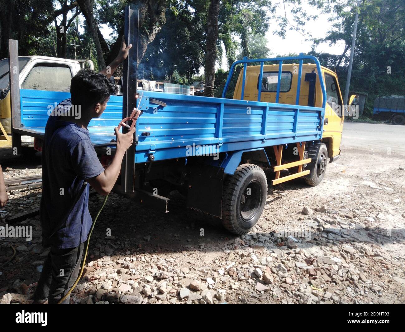 Vehicle Repairing by a expert worker in Bangladesh Stock Photo