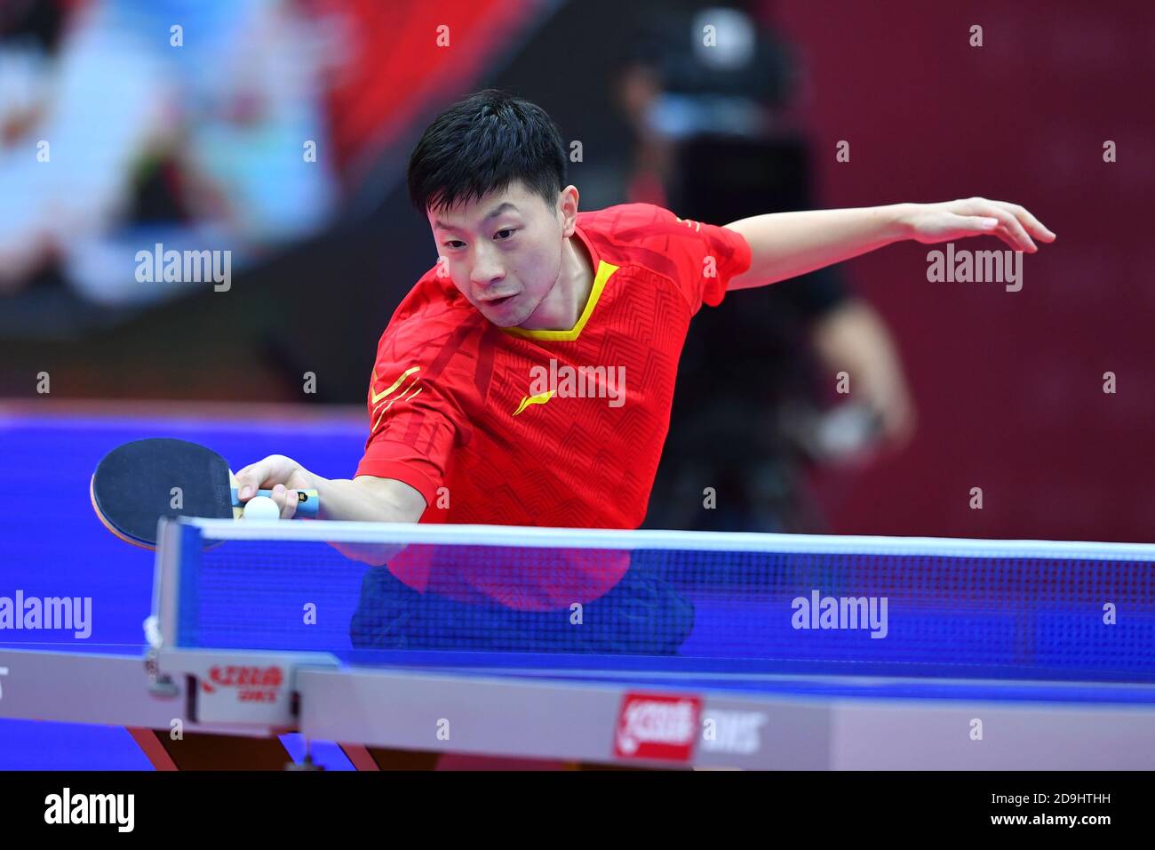 Chinese table tennis player Ma Long competes against Chinese table tennis player Wang Chuqin at