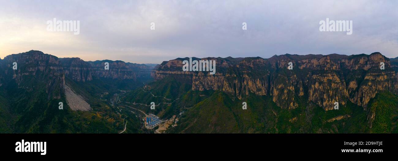 An aerial view of Taihang Mountains, a Chinese mountain range running down the eastern edge of the Loess Plateau, with trees becoming either red and y Stock Photo