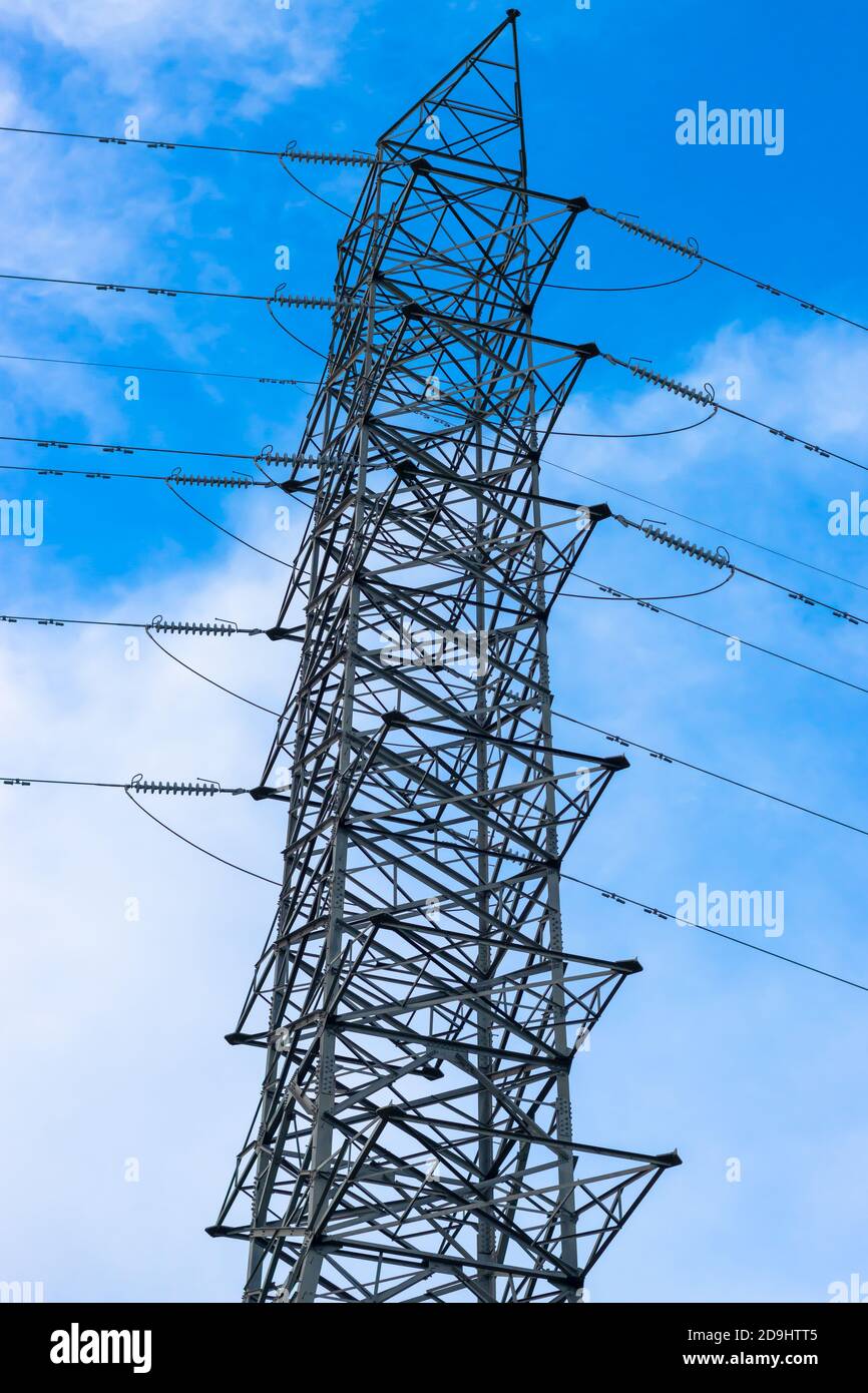 High voltage electricity tower under the blue sunny sky Stock Photo - Alamy