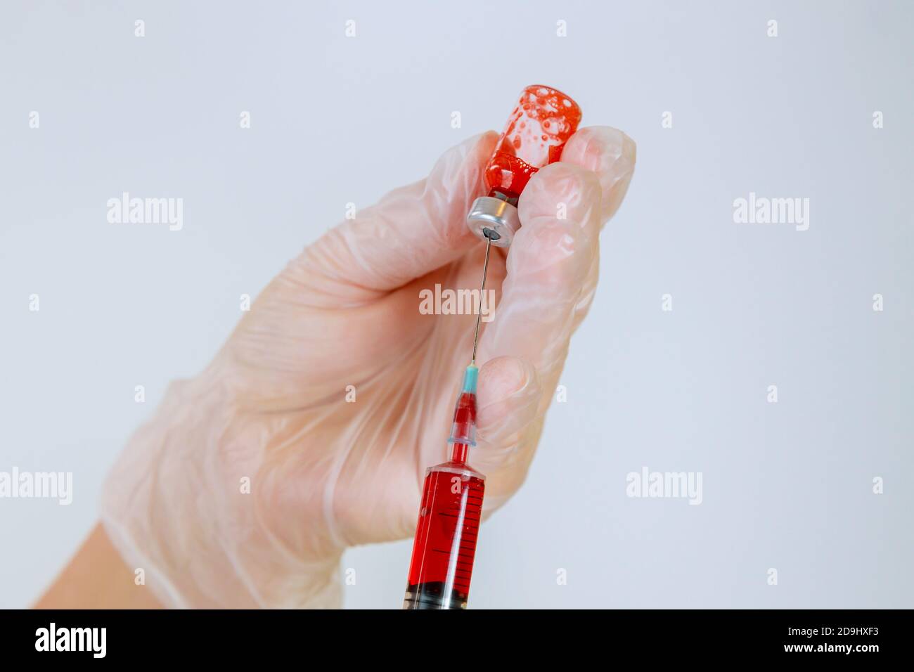 Hands nurse holding a patient's blood with mixes the the medication for injection on a isolated white background Stock Photo