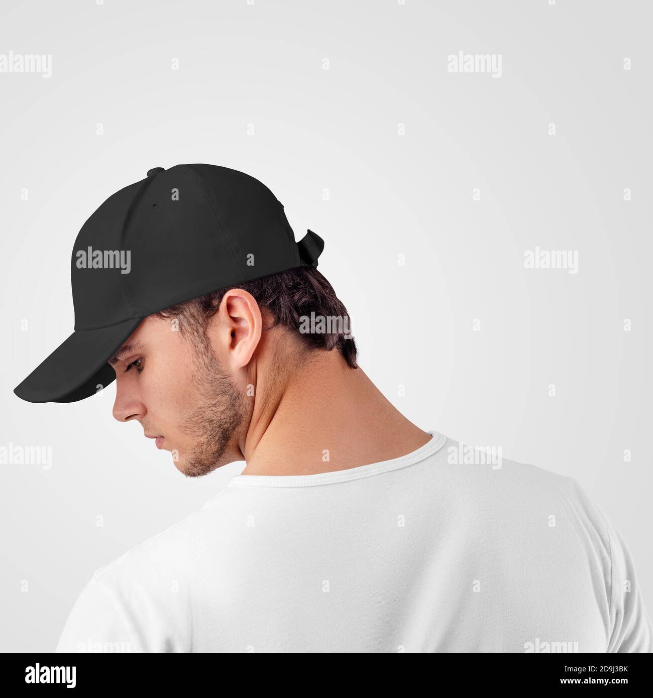Mockup of a black baseball cap on a guy standing backwards, for the presentation of design, pattern. Headdress template for sun protection, panama hat Stock Photo
