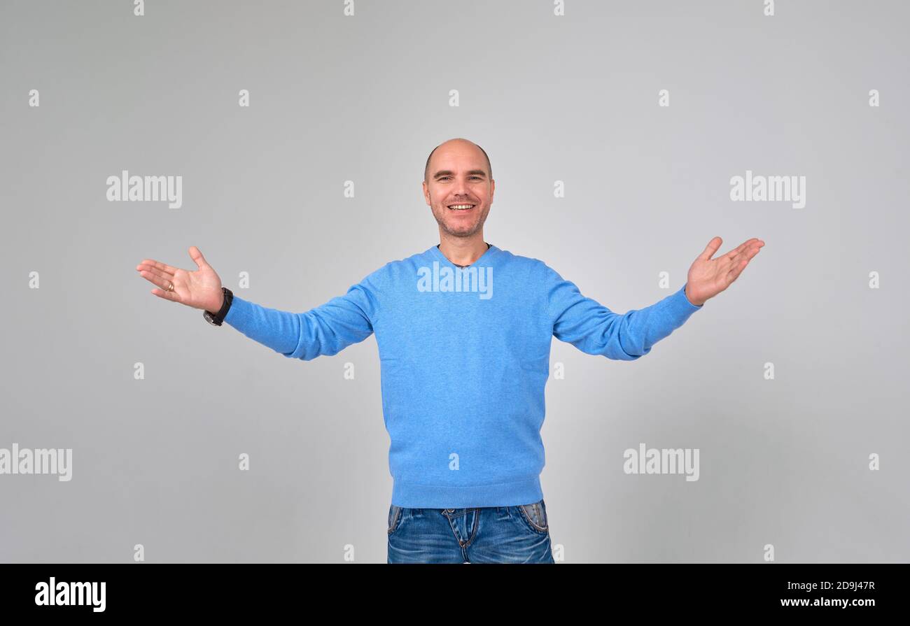 Casual handsome man smiling at camera, hands in pocket Stock Photo - Alamy