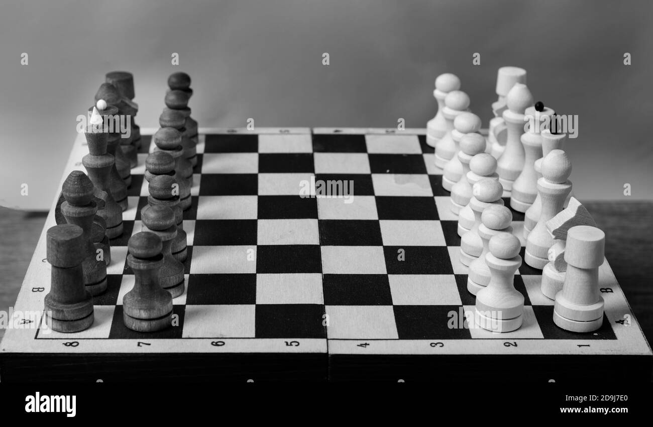 The beginning of a game of chess, pieces in a row, close-up, selective focus, black and white. Business concept start of business negotiations, business cooperation Stock Photo