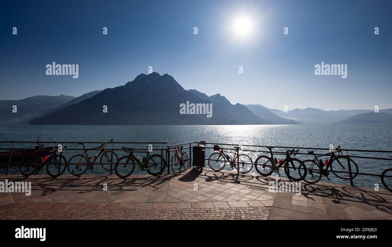Several sport bikes leaning on the railing of a high mountain alpine lake Stock Photo