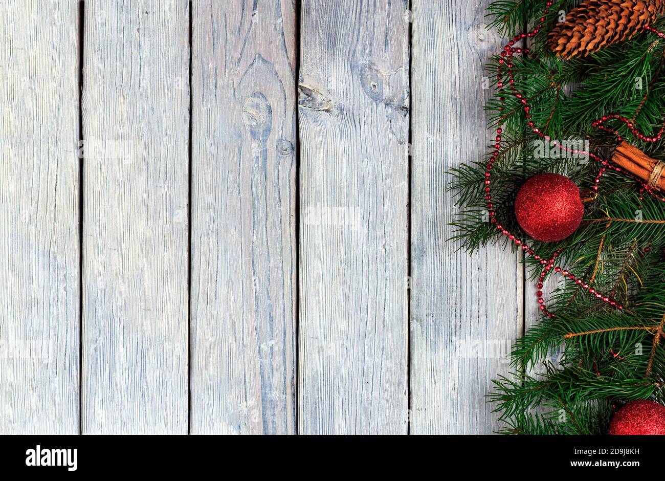 Christmas wooden light background with fir branches and christmas balls ...