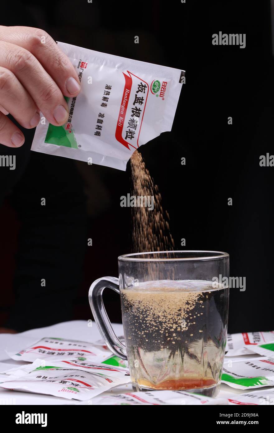 In this unlocated photo, a person pours a bag of Isatis Root, also known as Ban Lan Gen, which is widely used in China, 19 October 2020. *** Local Cap Stock Photo