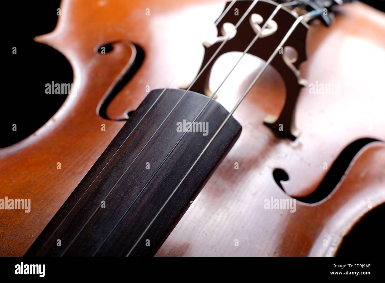 Vintage cello on a dark background. Cello details. Stock Photo