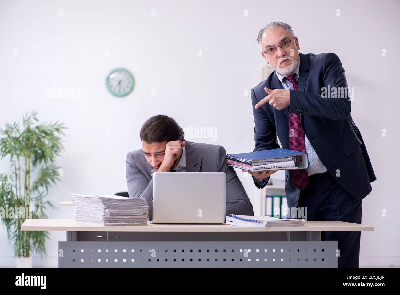 Old boss and his assistant working in the office Stock Photo - Alamy