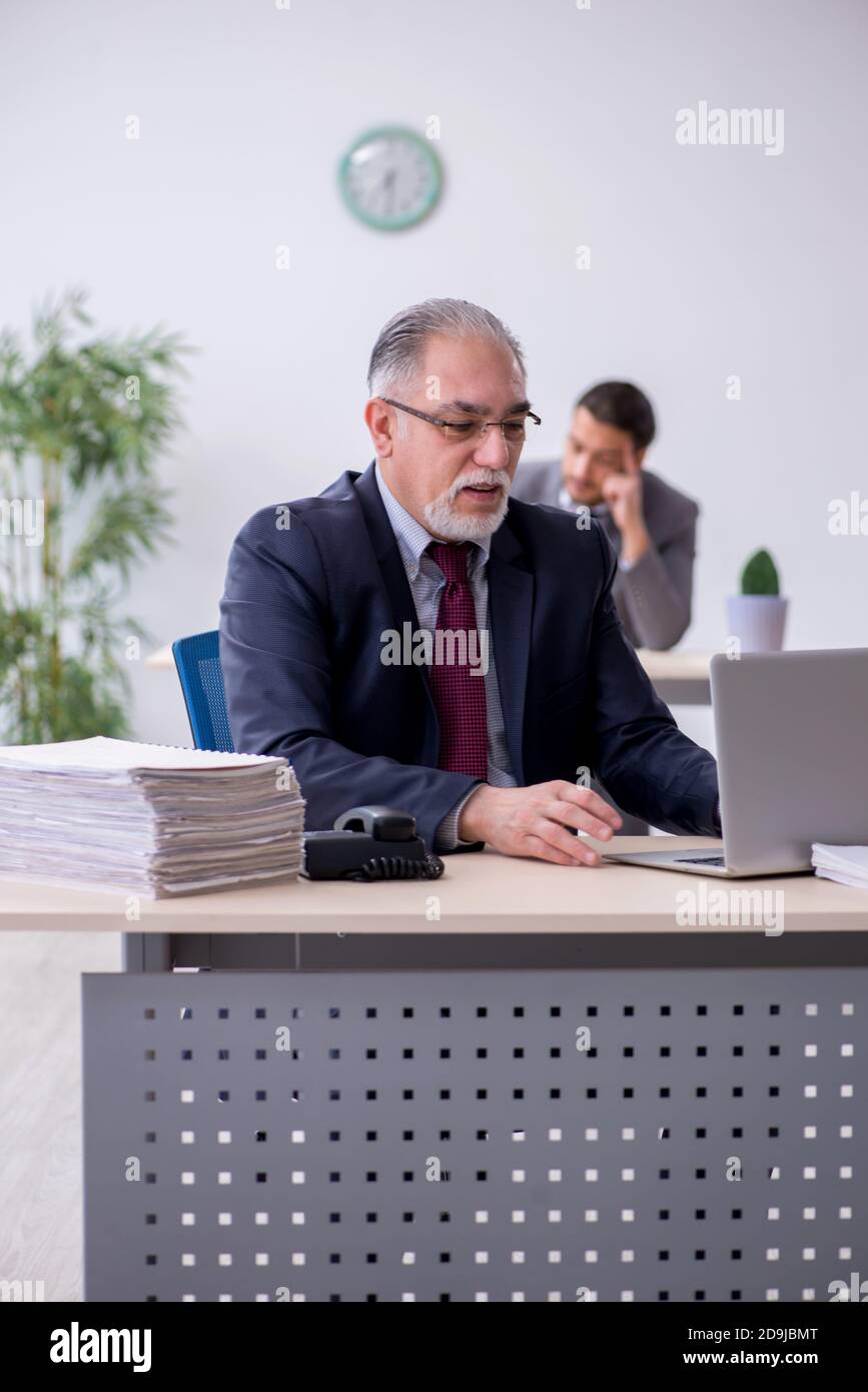 Old boss and his assistant working in the office Stock Photo - Alamy