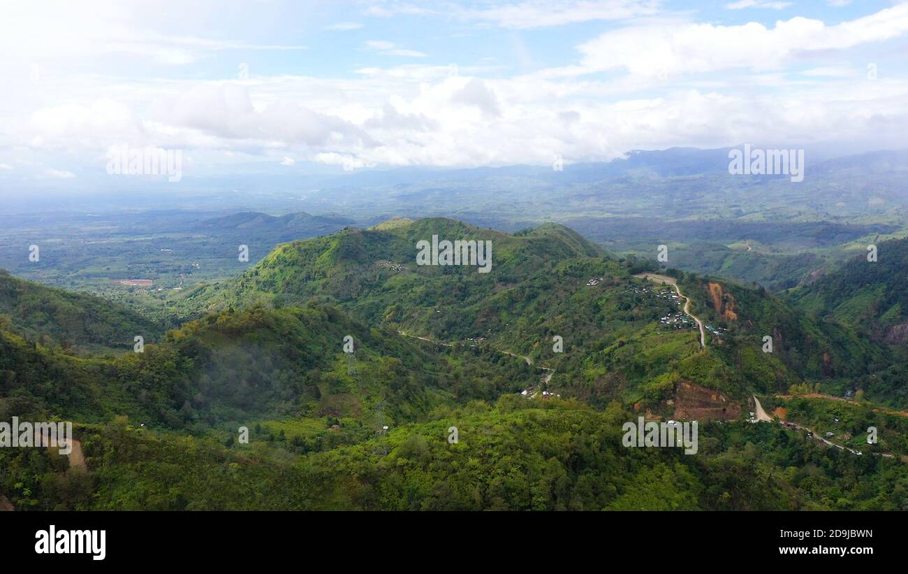 Lush green rainforest in the mountains. Aerial drone view of the jungle