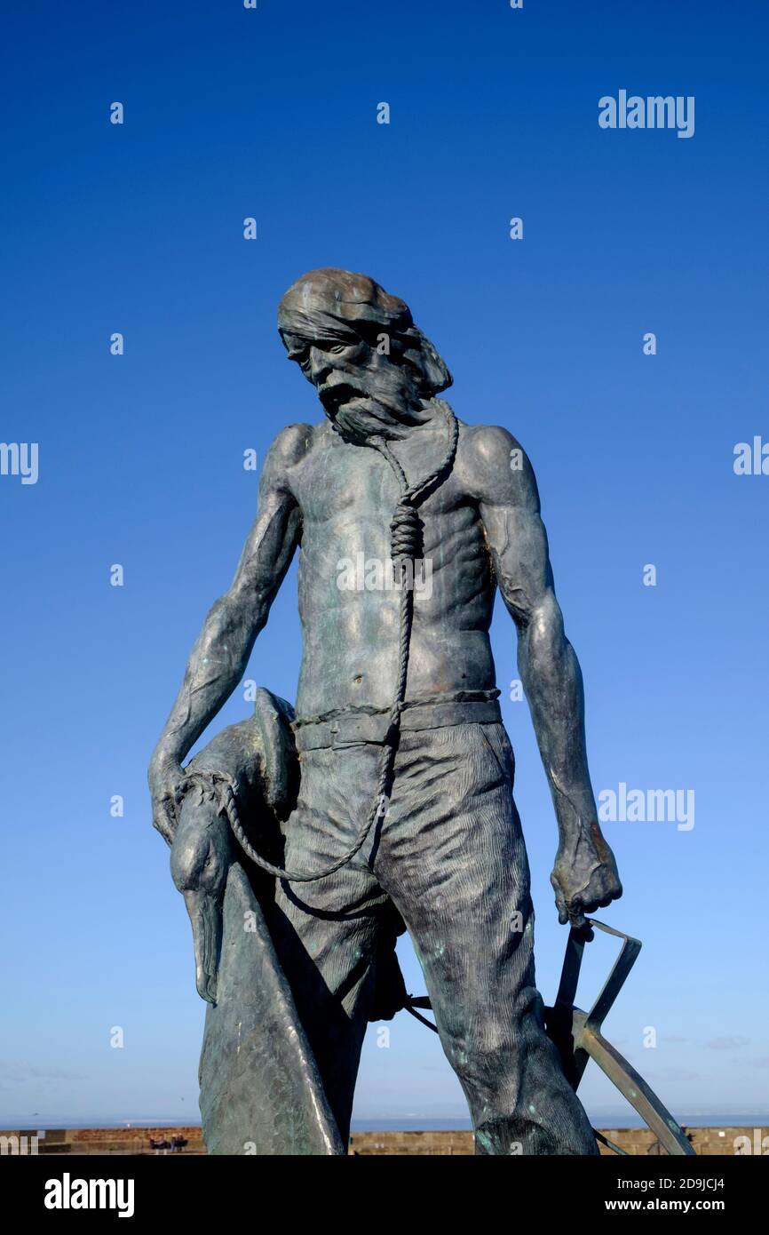 Statue of Coleridge's Ancient Mariner on a bright winter's day on Watchet harbour on the North somerset coast. Sculpted by Alan B. Herriot Stock Photo