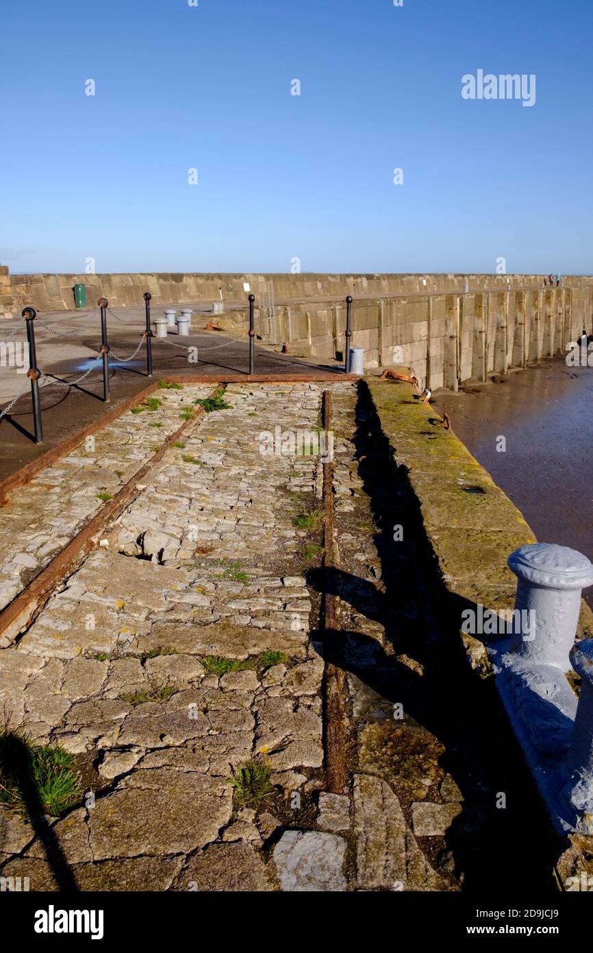 Bright winter's day on Watchet harbour on the North somerset coast. The harbour wall. Stock Photo
