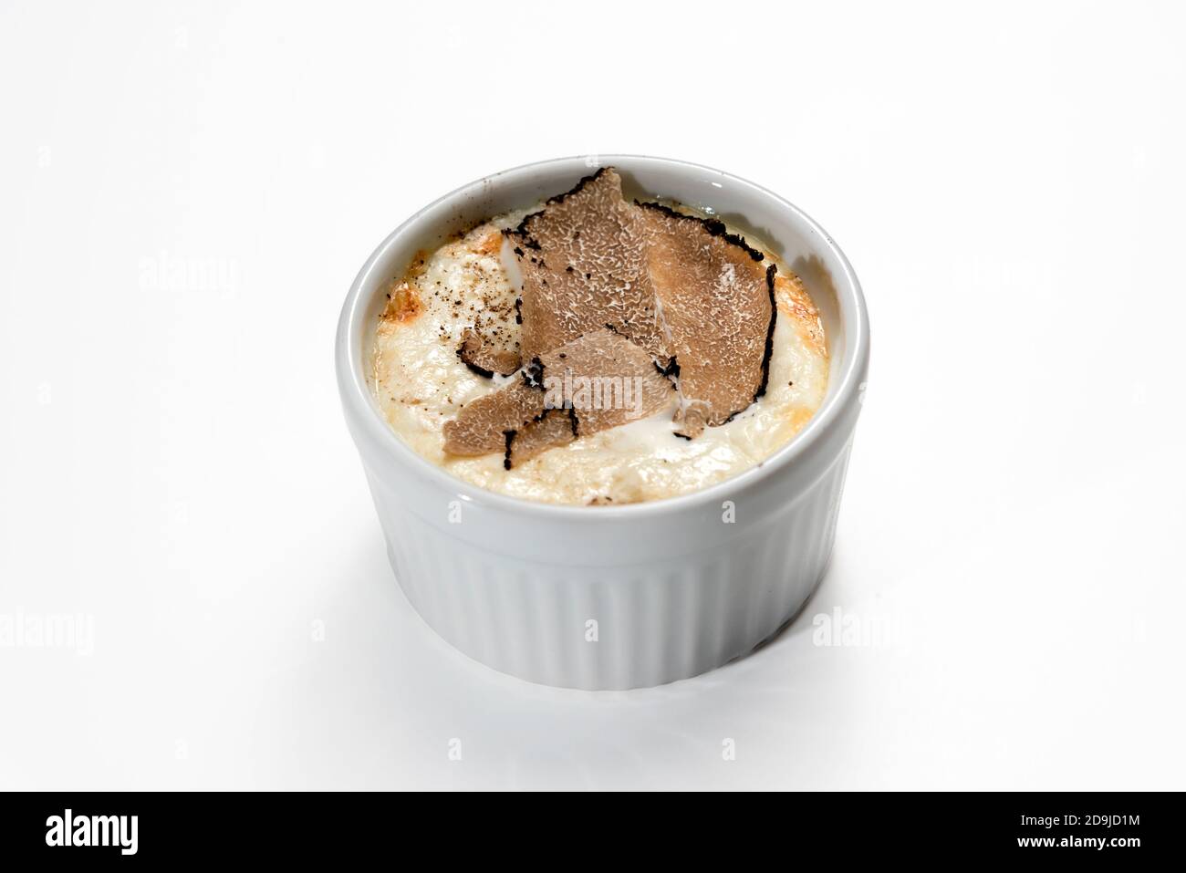 Baked egg and Fontina Cheese fondue with sliced truffle in a cocotte, isolated on white Stock Photo