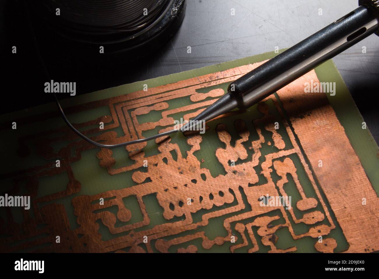 use a soldering iron to solder the electronic part to the Board. Computer repair. Macrophotography. Stock Photo